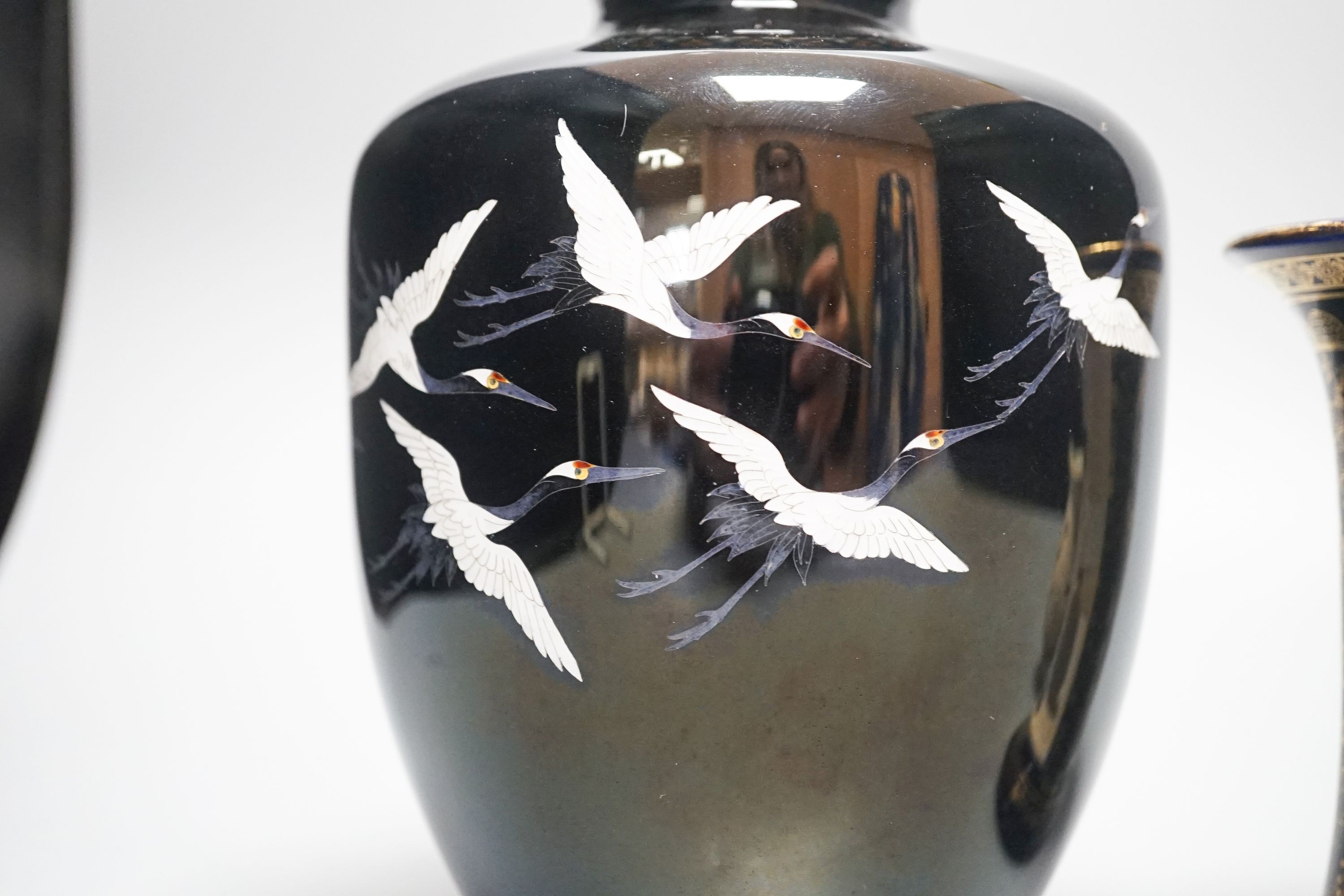 A Japanese black ground ‘cranes’ cloisonné enamel vase, 18.3cm, a Satsuma pottery vase and a crane decorated jug (3)